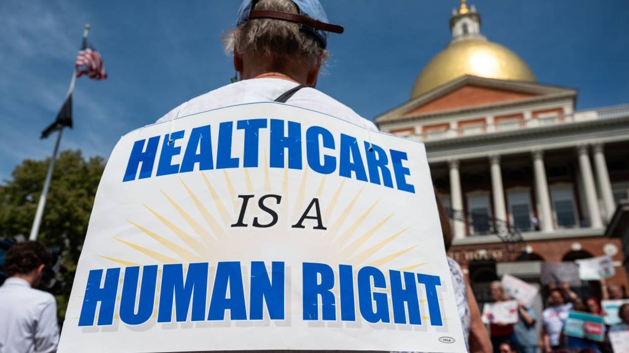 A sign says, "Healthcare is a human right."