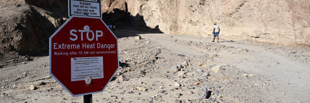 A sign says "Stop: Extreme Heat Danger" at the Golden Canyon Trailhead