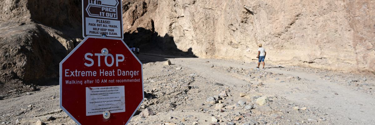 A sign says "Stop: Extreme Heat Danger" at the Golden Canyon Trailhead