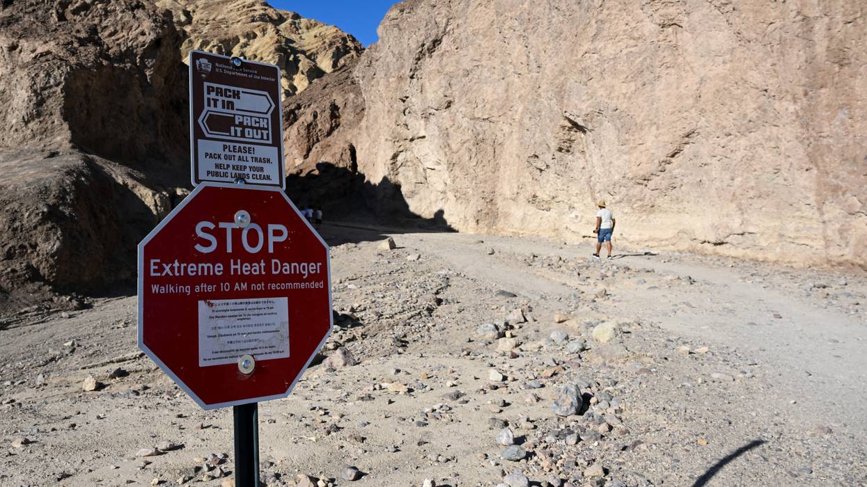 A sign says "Stop: Extreme Heat Danger" at the Golden Canyon Trailhead