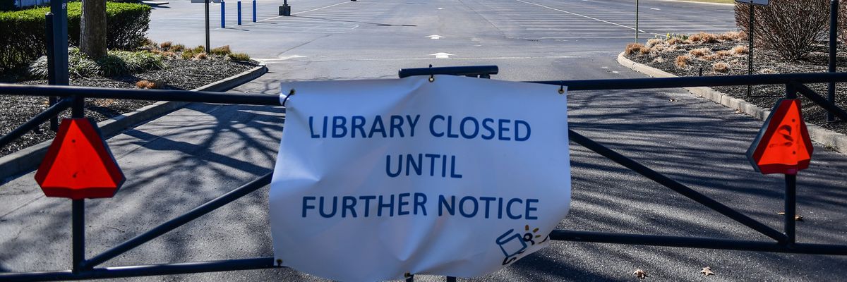 A sign says the Middle Country Public Library in Centereach, New York is closed until further notice during the Covid-19 pandemic on March 26, 2020.