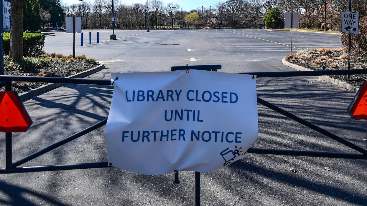 A sign says the Middle Country Public Library in Centereach, New York is closed until further notice during the Covid-19 pandemic on March 26, 2020.