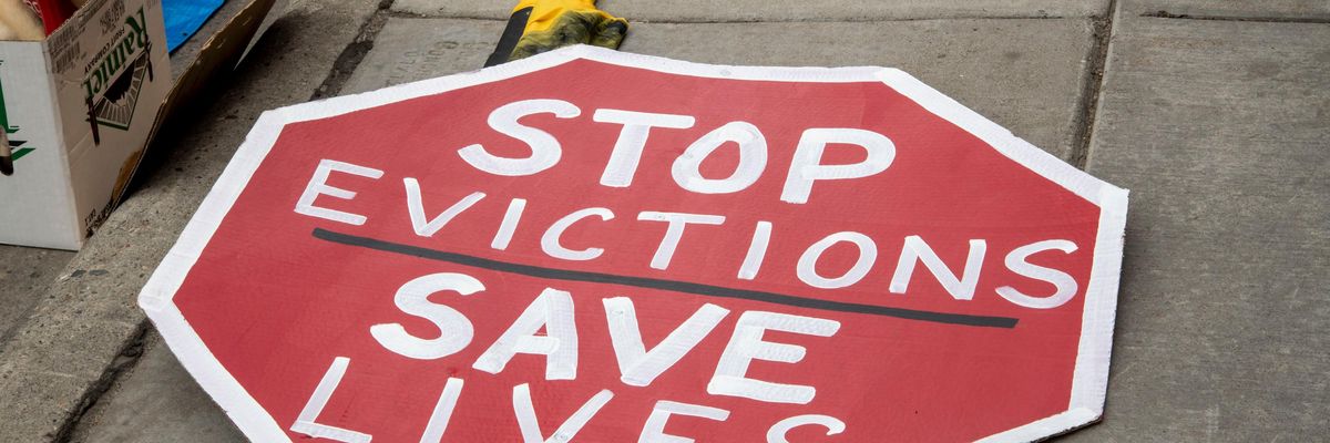 A sign that reads, "Stop Evictions, Save Lives"