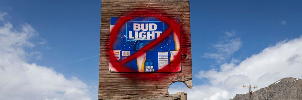 A sign with a red warning label placed over the Bud Light logo.