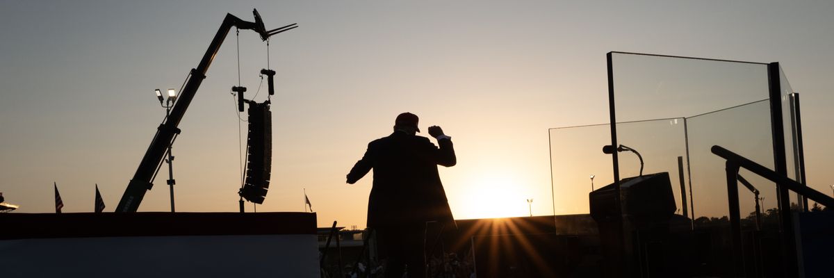 A silhouette of Trump posing to a crowd.