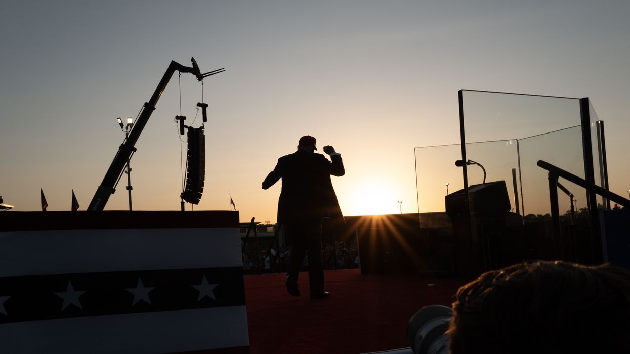 A silhouette of Trump posing to a crowd.