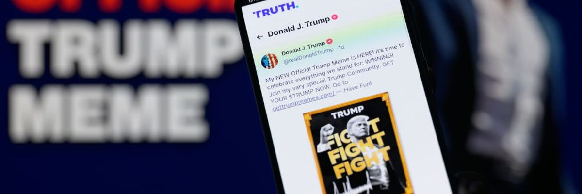 A smartphone displays a post from U.S. President-elect Donald Trump's Truth account announcing the $TRUMP