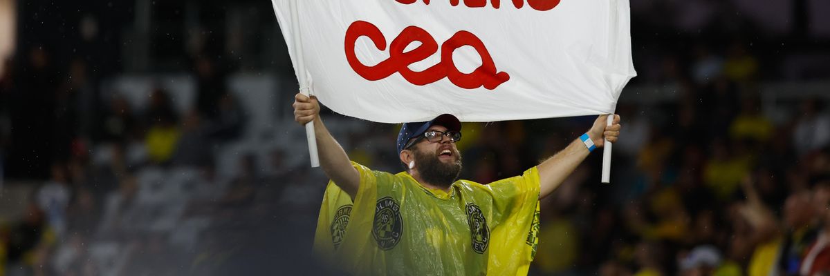 A soccer fan holds a sign in support of teachers during a match between the Columbus Crew and Atlanta United on August 21, 2022 in Columbus, Ohio.
