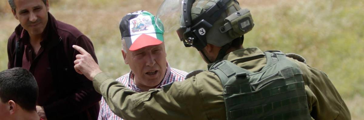 A soldier yells at a man.