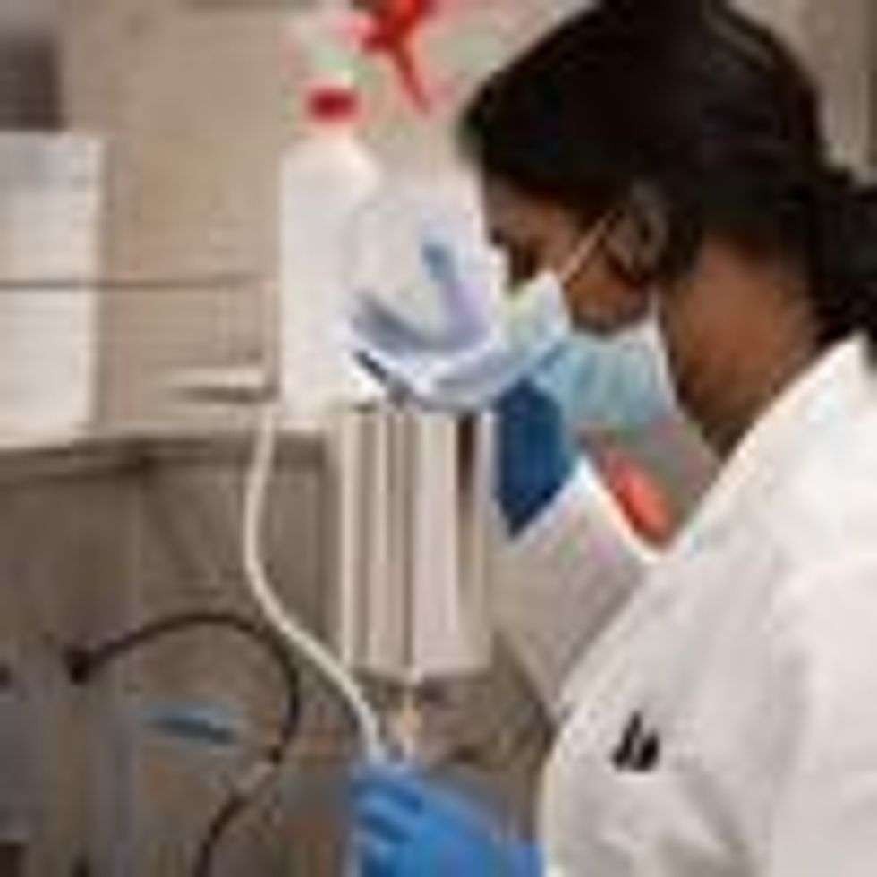 A South African researcher works in a vaccine lab