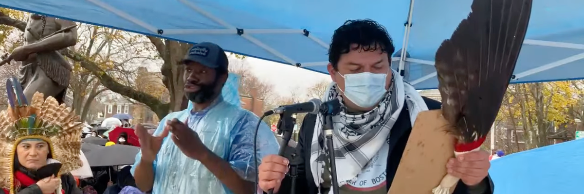 A speaker is introduced at the National Day of Mourning in Plymouth