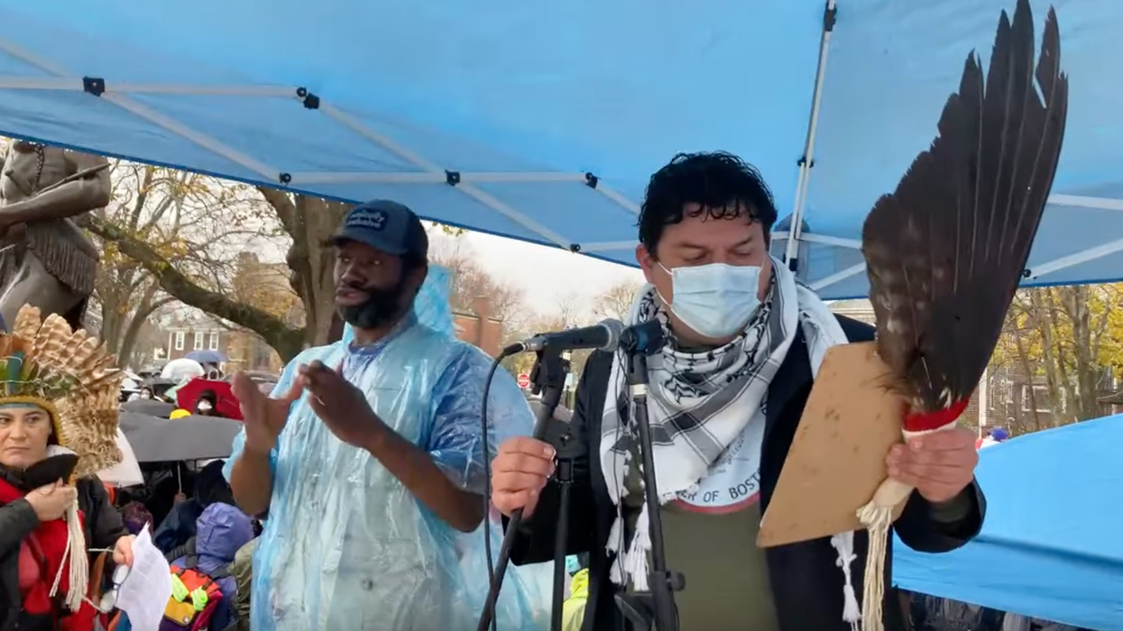 A speaker is introduced at the National Day of Mourning in Plymouth