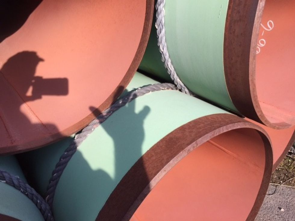 A stack of properly coated pipeline pipes.