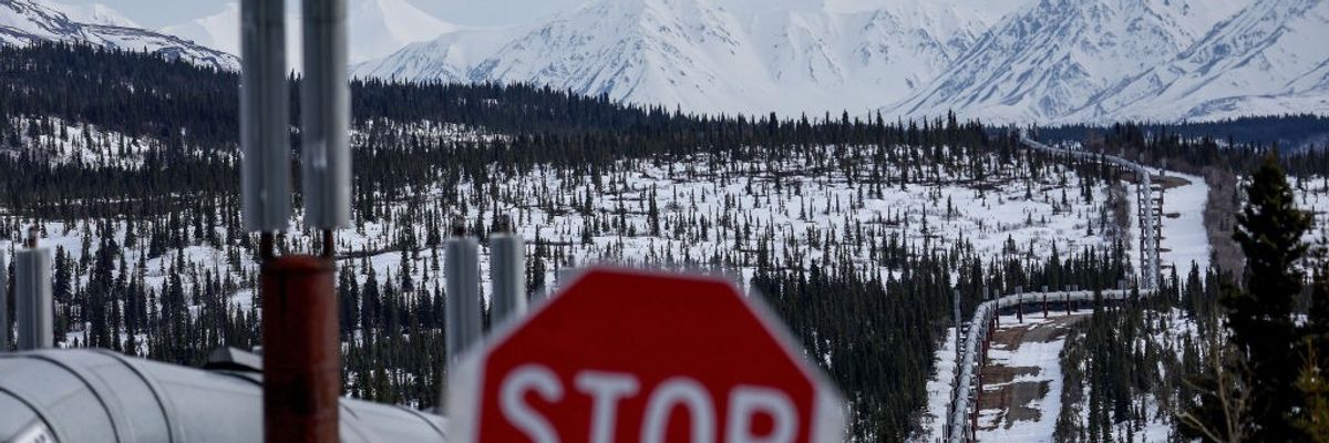 A Stop sign in front of a pipeline system in Alaska.