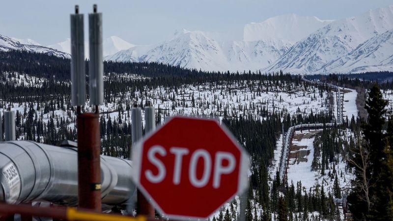 A Stop sign in front of a pipeline system in Alaska.