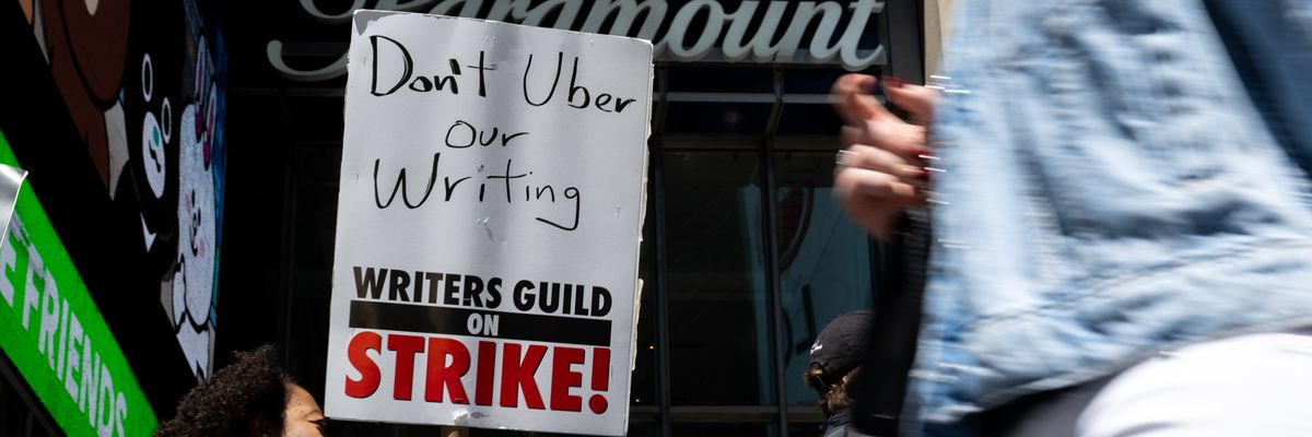 A striking worker holds a sign. 