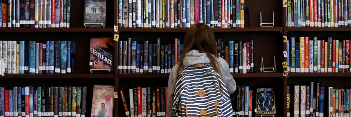 A student browses through books in the Presidio Middle School library