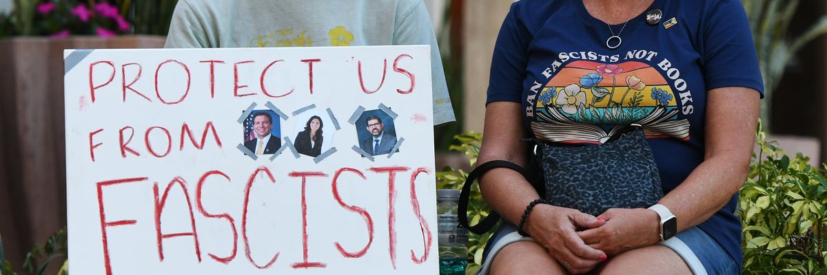 A student holds a placard during a rally protesting Florida education policies