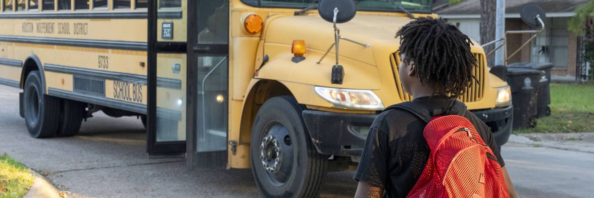 A student walks to a school bus