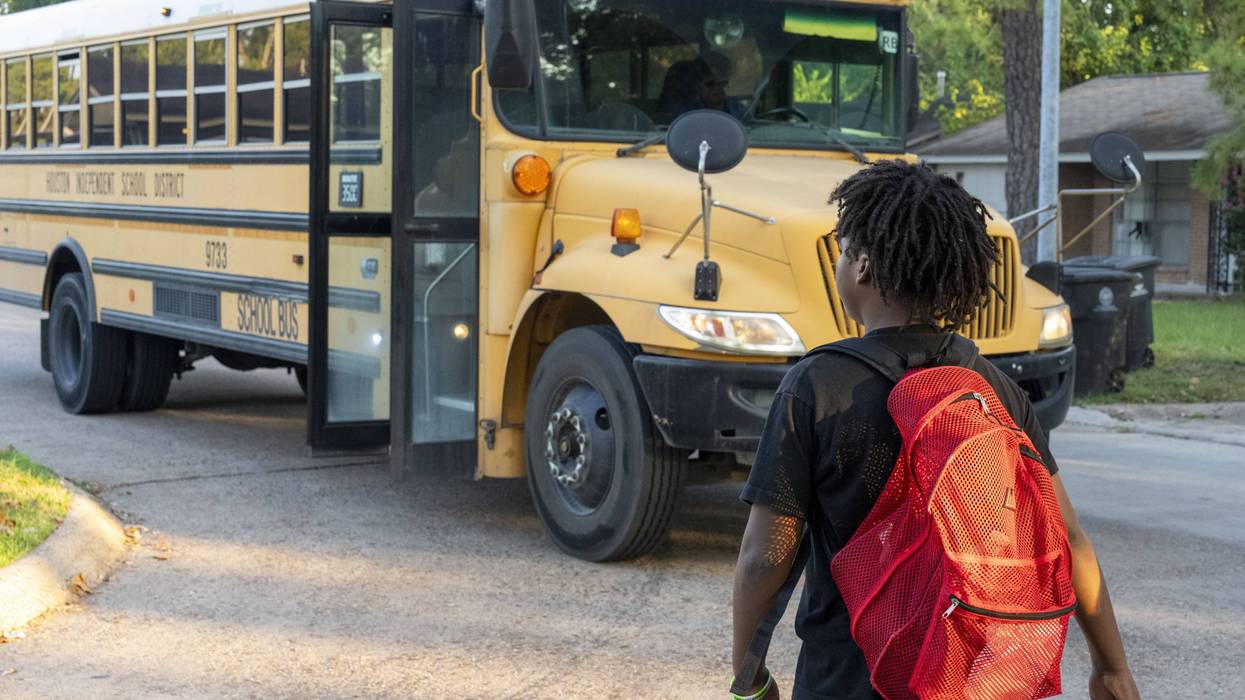 A student walks to a school bus