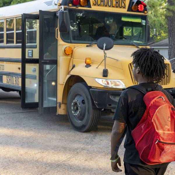 A student walks to a school bus