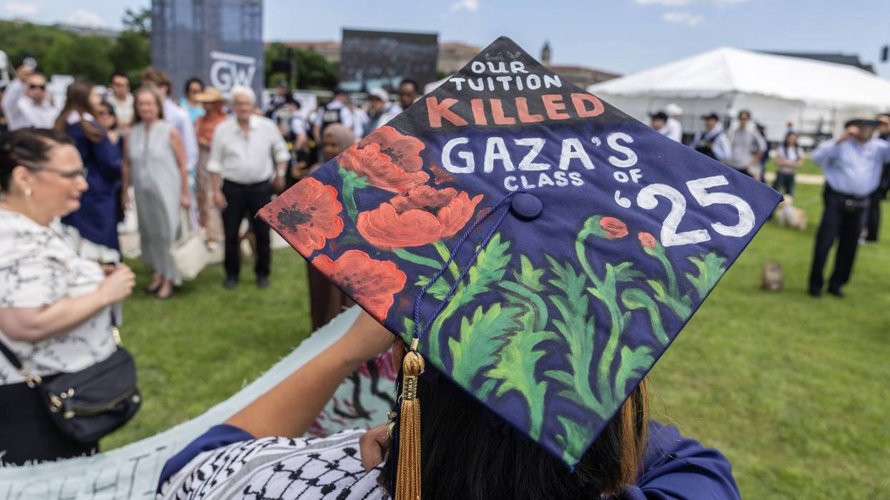 A student wearing a graduation cap with the message "Our