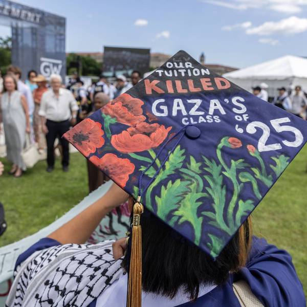 A student wearing a graduation cap with the message "Our