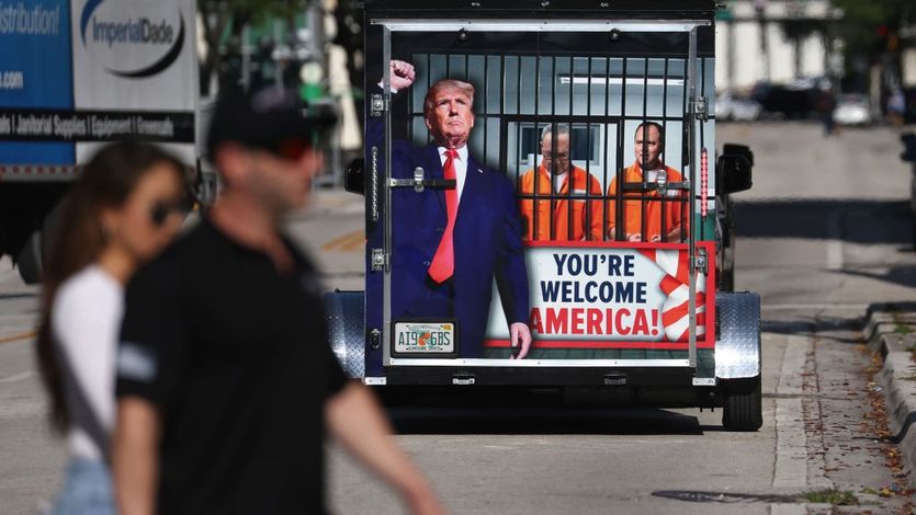 A supporter of former President Donald Trump with sign "You're Welcome America"