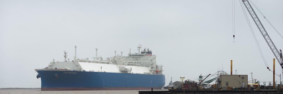 A tanker moves on gray water.
