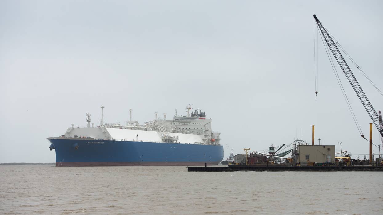 A tanker moves on gray water.