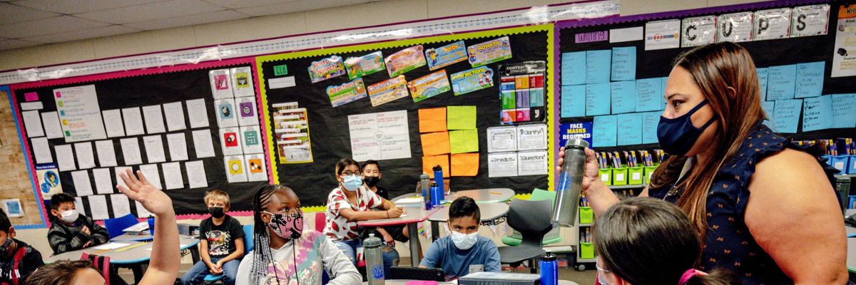 A teacher speaks with 5th grade students