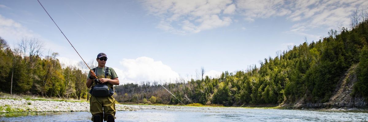 A teen fishes on a tributary river of the Lake Huron.