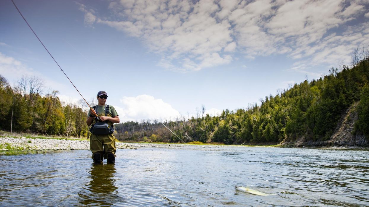 A teen fishes on a tributary river of the Lake Huron.