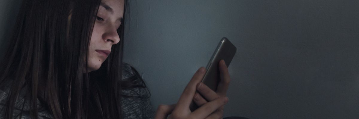 A teen uses her cellphone