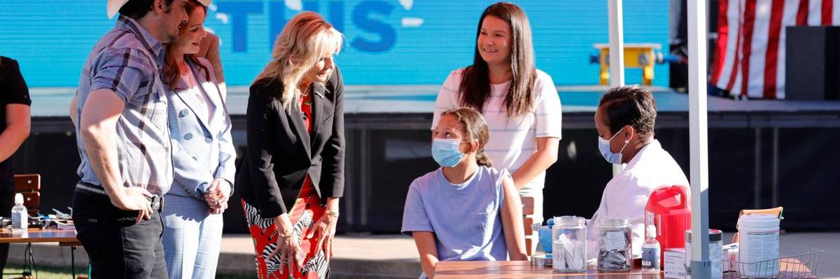 A teenage girl is vaccinated against Covid-19 at an event attended by First Lady Jill Biden.