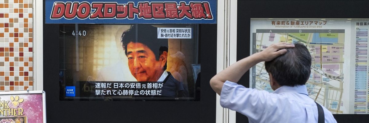 A television broadcast shows news of the attack on former Japanese Prime Minister Shinzo Abe