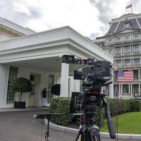 A television camera is pointed at the entrance of the White House
