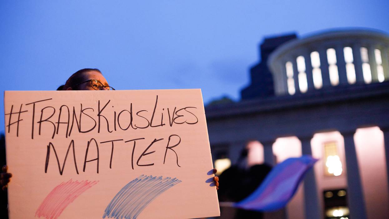 A transgender rights advocate holds a sign
