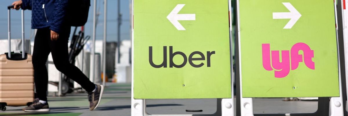 A traveler walks toward the Uber ride-hailing vehicle pickup area