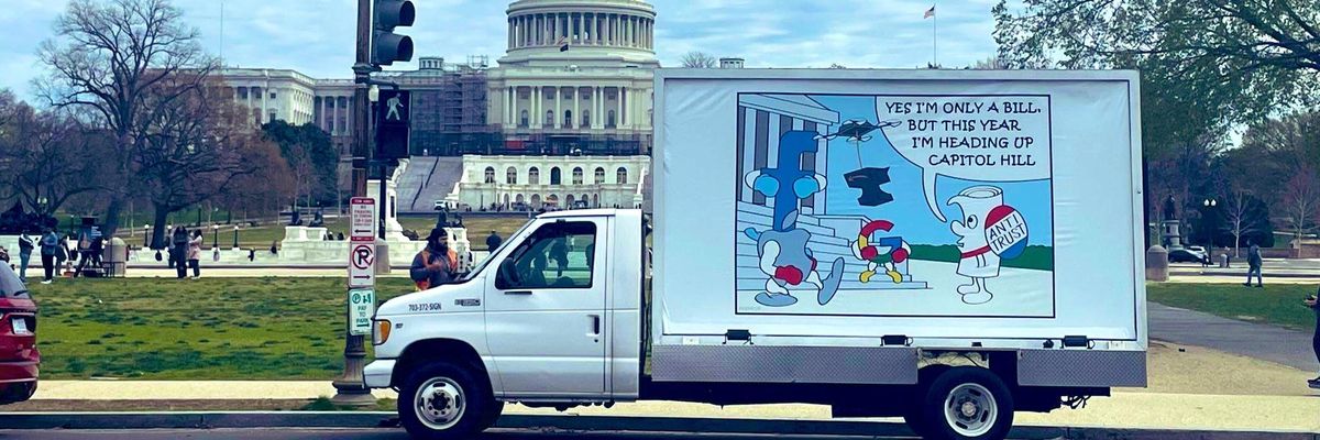 A truck displays a cartoon on Antitrust Day 