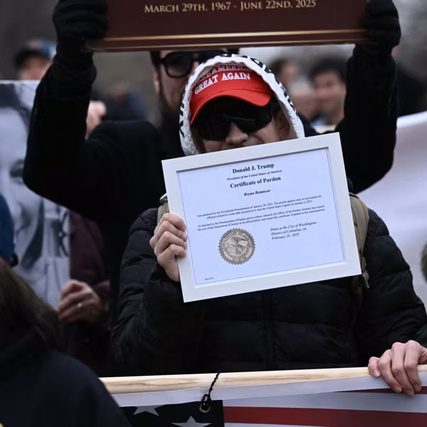 A Trump supporter holds up a certificate of pardon in connection with the January 6, 2021 Capitol insurrection