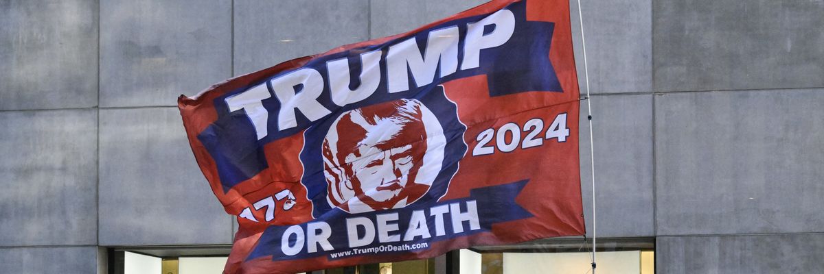 A Trump-themed flag is flown by supporters across the street from Trump Tower
