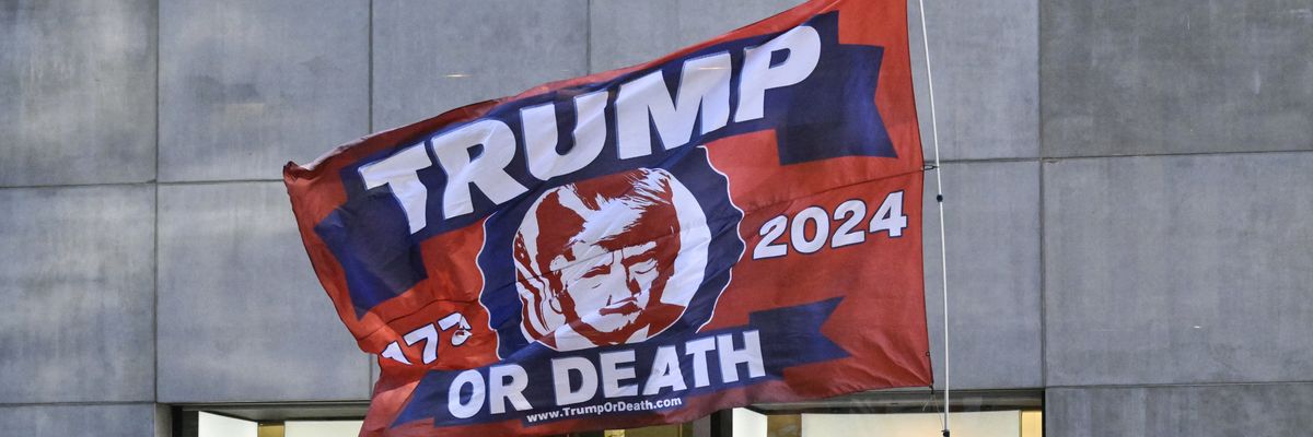 A Trump-themed flag is flown by supporters across the street from Trump Tower