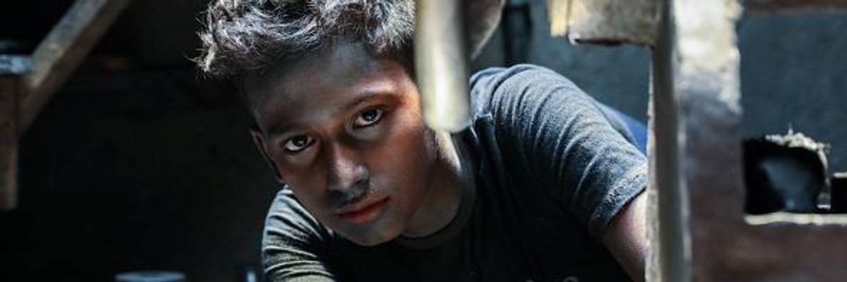 A twelve-year-old works in a silver cooking pot factory in Dhaka, Bangladesh on May 30, 2020.