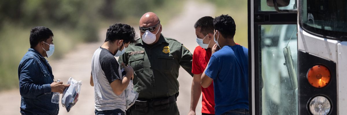A U.S. Border Patrol agent instructs unaccompanied teenagers