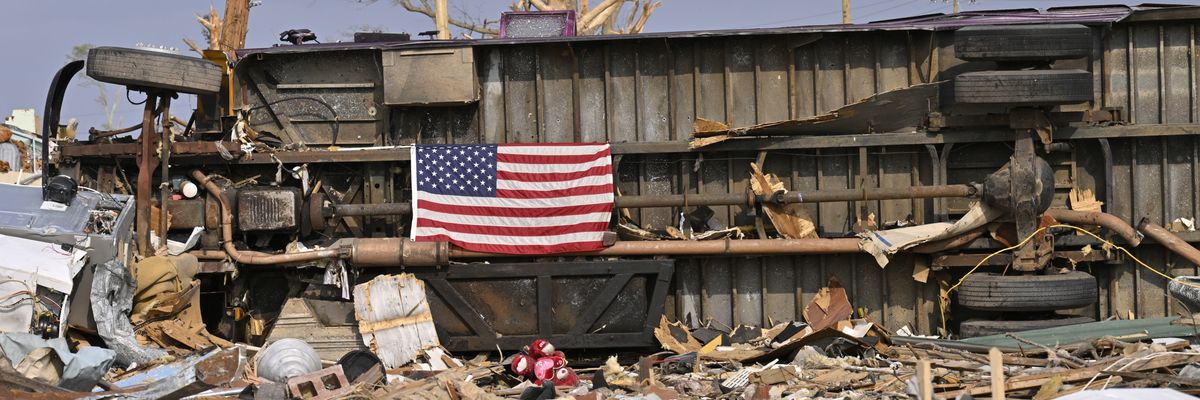 A U.S. flag displayed amidst rubble.