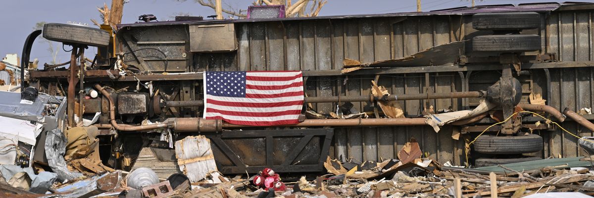 A U.S. flag displayed amidst rubble. 