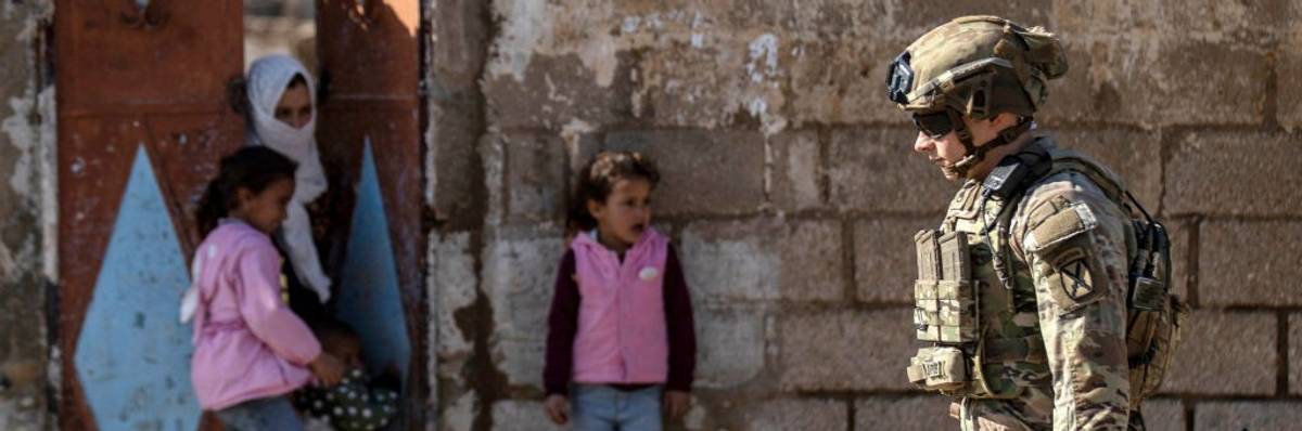 A U.S. soldier patrols an area in the town of Tal Hamis, southeast of the city of Qameshli in Syria's northeastern Hasakeh governorate, on January 24, 2024.