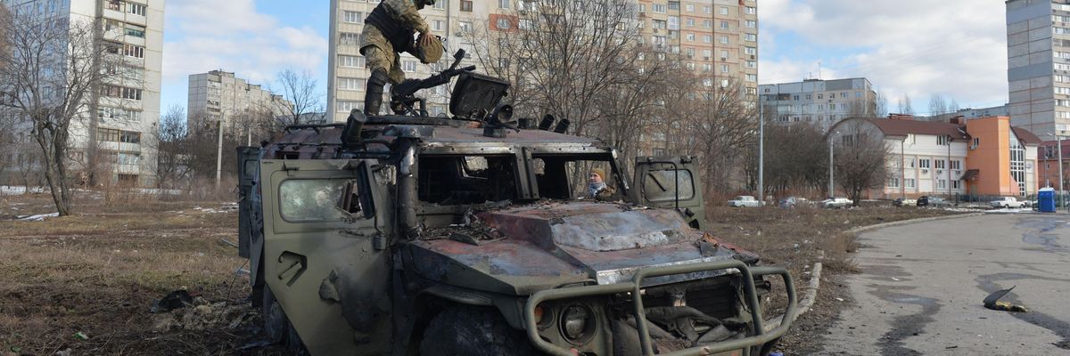 A Ukrainian soldier examines a destroyed Russian infantry mobility vehicle after fighting in Kharkiv, Ukraine on February 27, 2022.