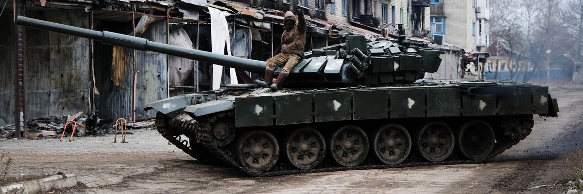 A Ukrainian tank drives down a street in the heavily damaged town of Siversk